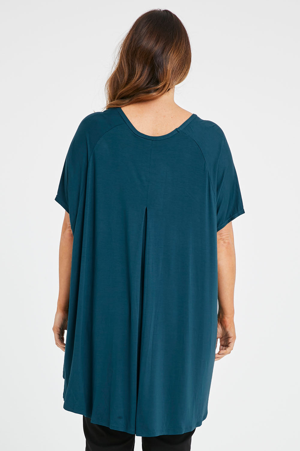 Model Laura wearing size 14 of the Belle High Low Bamboo Tee in colour Petrol (Blue), from the back