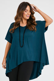 Model Laura wearing size 14 of the Belle High Low Bamboo Tee in colour Petrol (Blue), from the front, cropped image