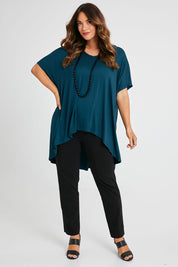 Model Laura wearing size 14 of the Belle High Low Bamboo Tee in colour Petrol (Blue), from the front, showing the whole outfit