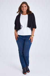 Model Monique wearing size 14 of the Belle Cotton Sateen Cropped Jacket in colour Black (Black), from the front, showing the whole outfit