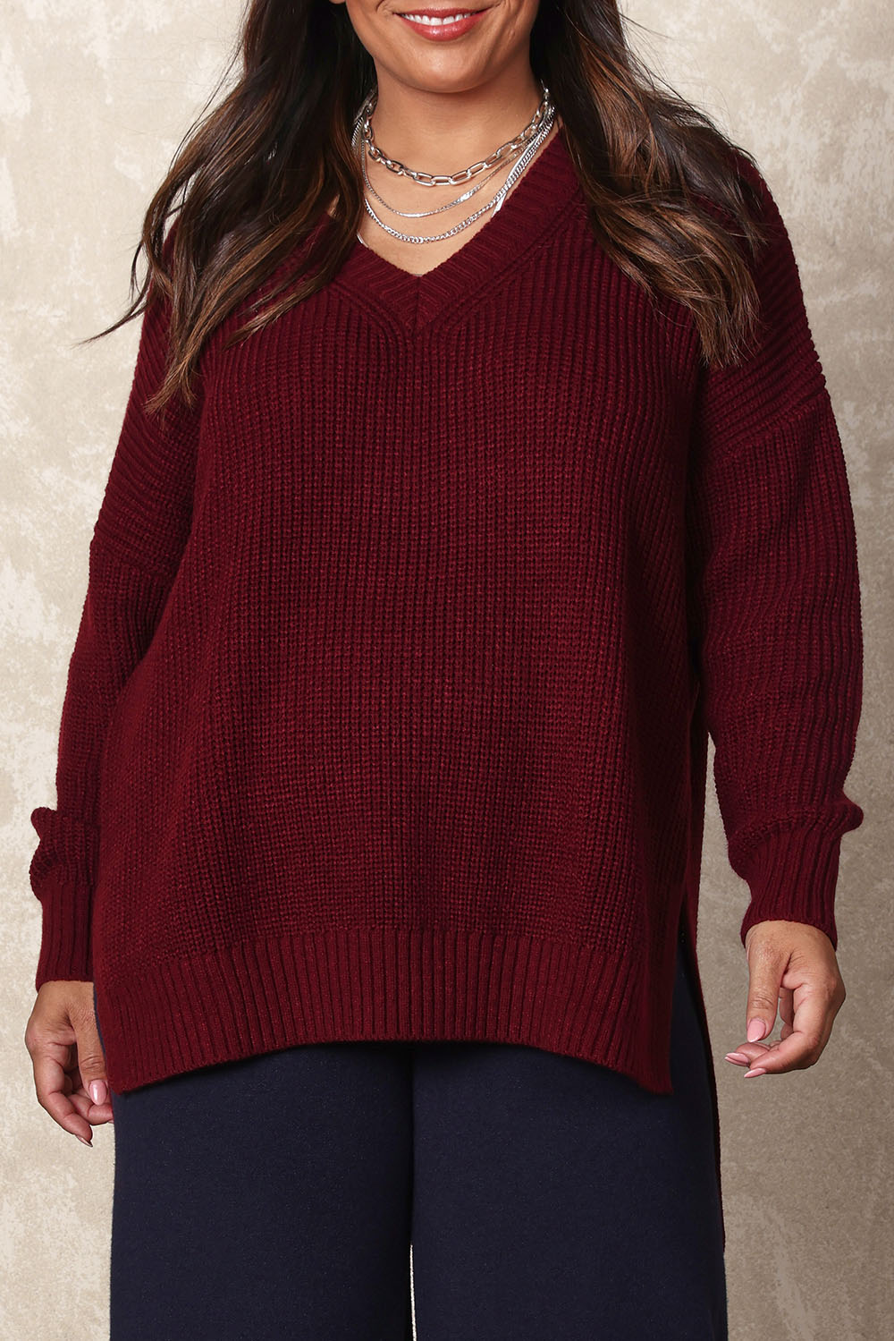 Model Ashleigh wearing size XL of the Belle Cosy V Neck Jumper in colour Burgundy (Purple), from the front, cropped image