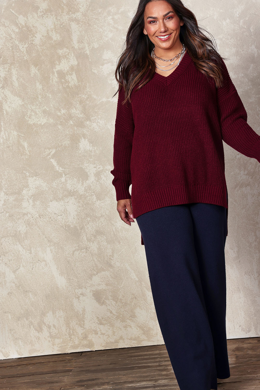 Model Ashleigh wearing size XL of the Belle Cosy V Neck Jumper in colour Burgundy (Purple), from the front, showing the whole outfit