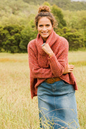Model Ilona wearing size S of the Soft Cloud Roll Neck Jumper in colour Brick (Red), from the front, showing the whole outfit