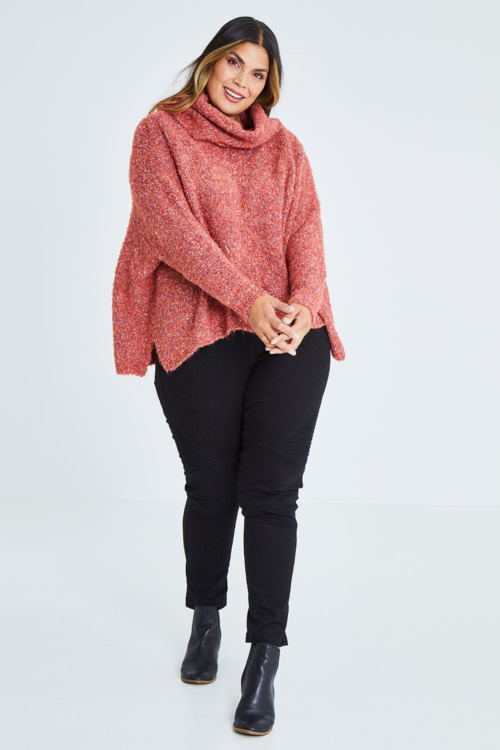 Model Palatina wearing size XL of the Soft Cloud Roll Neck Jumper in colour Brick (Red), from the front, showing the whole outfit
