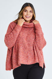 Model Palatina wearing the Soft Cloud Roll Neck Jumper in colour Brick (Red), from the front, cropped image