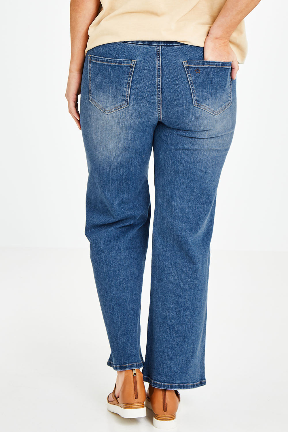 Model Laura wearing size 14 of the Preloved Easy As Pull On Jeans in colour Denim (Blue), from the back