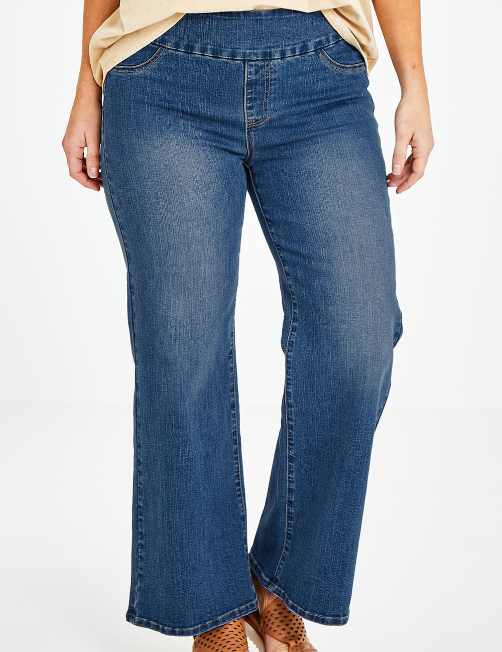 Model Laura wearing size 14 of the Preloved Easy As Pull On Jeans in colour Denim (Blue), from the front, cropped image