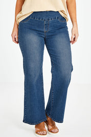 Model Laura wearing size 14 of the Preloved Easy As Pull On Jeans in colour Denim (Blue), from the front, cropped image
