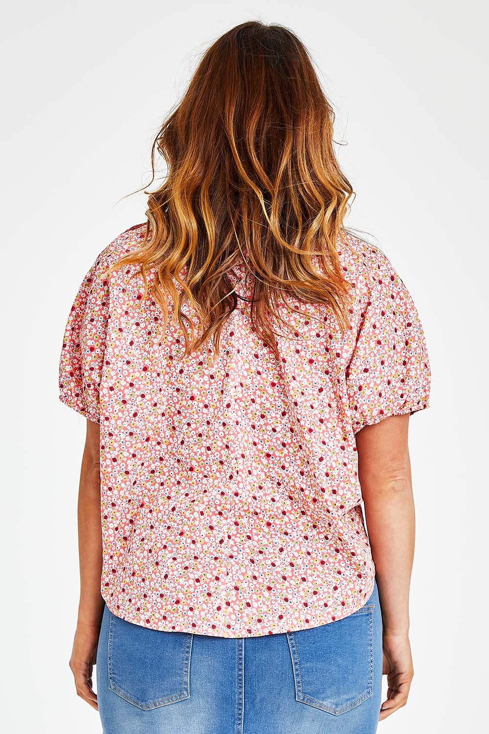 Model Laura wearing size 14 of the Its All In The Sleeve Cotton Blouse in colour Peach (Pink), from the back