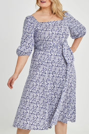 Model Keeara wearing size 16 of the Walking On Sunshine Dress in colour Navypais (Blue), from the front, cropped image