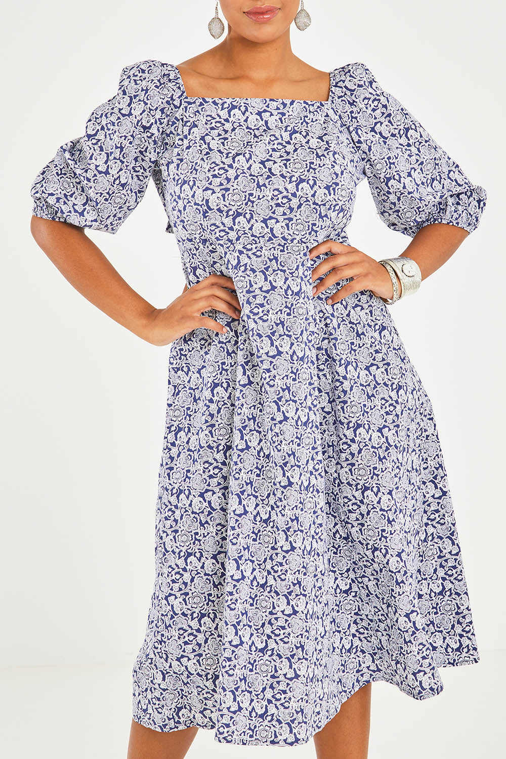 Model Noli wearing size 10 of the Walking On Sunshine Dress in colour Navypais (Blue), from the front, cropped image