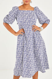 Model Noli wearing size 10 of the Walking On Sunshine Dress in colour Navypais (Blue), from the front, cropped image