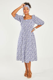 Model Noli wearing size 14 of the Walking On Sunshine Dress in colour Navypais (Blue), from the front, showing the whole outfit