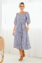 Model Tegan wearing size 10 of the Walking On Sunshine Dress in colour Navypais (Blue), from the front, showing the whole outfit