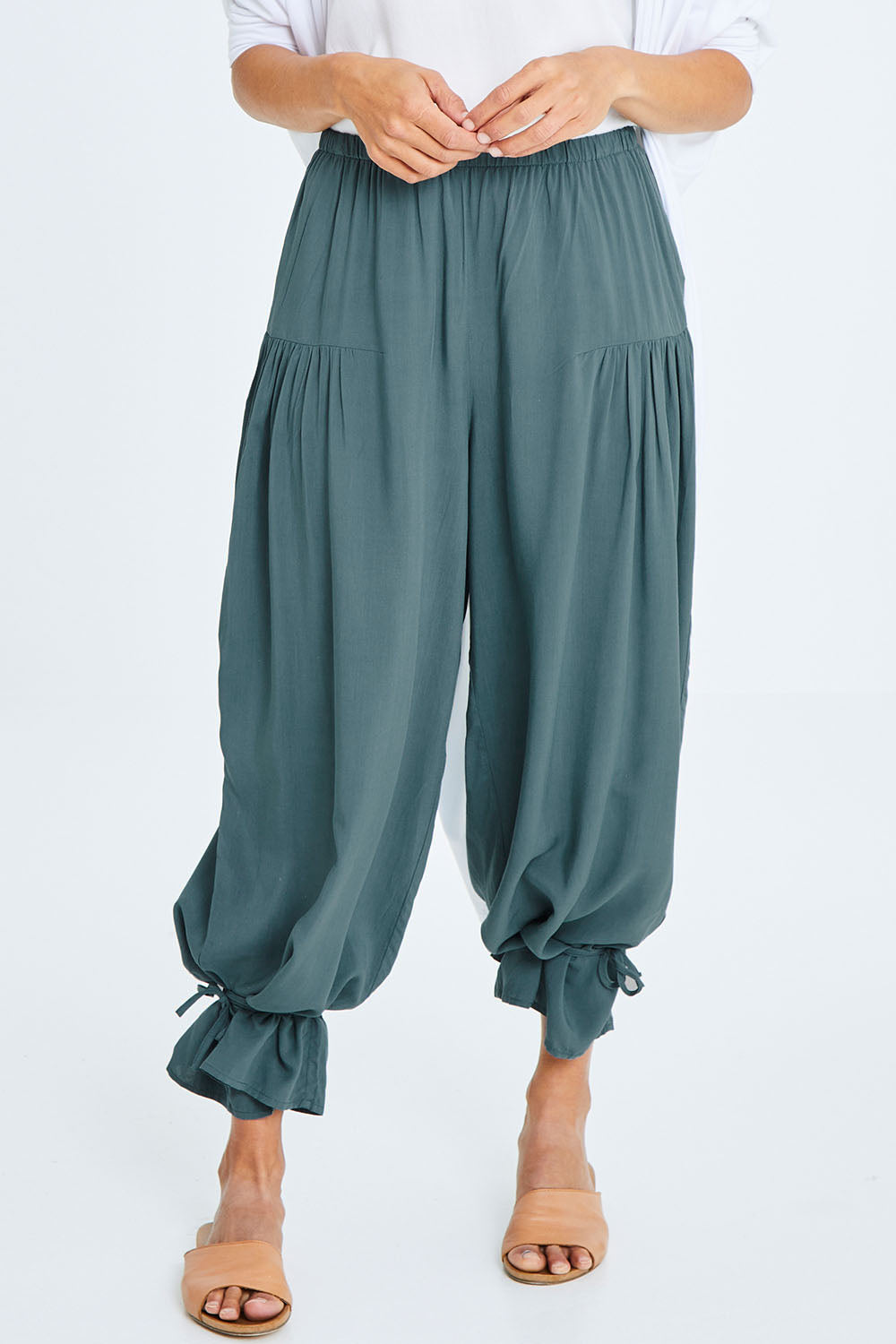 Model Cara wearing size 10 of the Endless Summer Side Gathered Pant in colour Forest (Green), from the front, cropped image