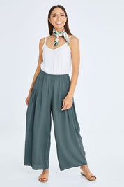 Model Cara wearing size 10 of the Endless Summer Side Gathered Pant in colour Forest (Green), from the front, showing the whole outfit
