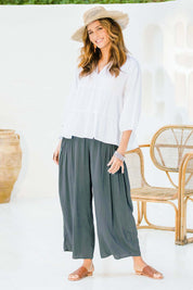 Model Ilona wearing size 10 of the Endless Summer Side Gathered Pant in colour Forest (Green), from the front, showing the whole outfit