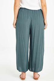 Model Laura wearing size 14 of the Endless Summer Side Gathered Pant in colour Forest (Green), from the back