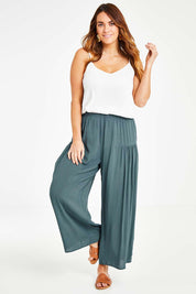 Model Laura wearing size 14 of the Endless Summer Side Gathered Pant in colour Forest (Green), from the front, showing the whole outfit