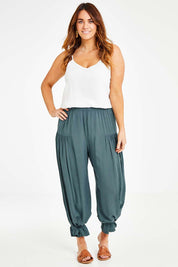 Model Laura wearing size 14 of the Endless Summer Side Gathered Pant in colour Forest (Green), from the front, showing the whole outfit