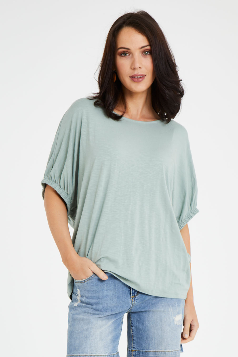 Model Andrea wearing size 10 of the In My Arms Tee in colour Sage (Green), from the front, cropped image