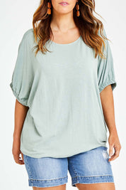 Model Laura wearing size 14 of the In My Arms Tee in colour Sage (Green), from the front, cropped image