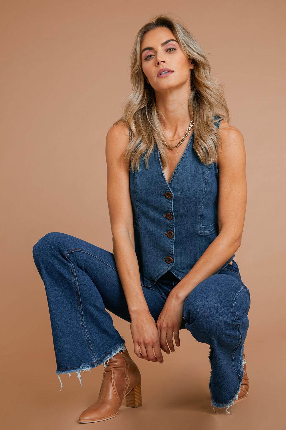 Model Alice wearing size 10 of the Fine and Dandy Denim Vest in colour Darkdenim (Blue), from the front, showing the whole outfit