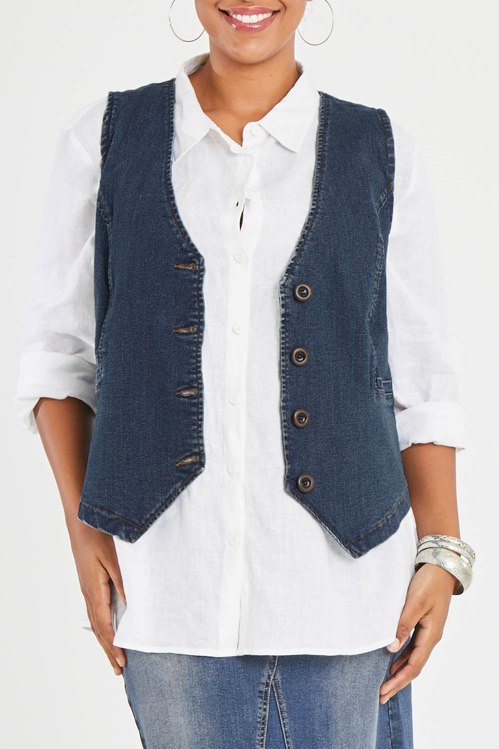 Model Noli wearing size 14 of the Preloved Fine and Dandy Denim Vest in colour Darkdenim (Blue), from the front, cropped image