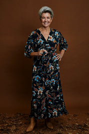 Model Elise wearing size 10 of the Feeling Free Faux Wrap Dress in colour Greenbay (Green), from the front, showing the whole outfit