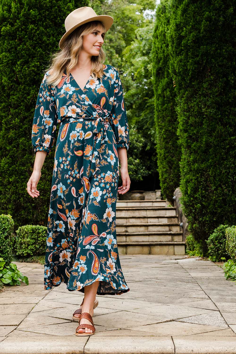 Model Tegan wearing size 10 of the Feeling Free Faux Wrap Dress in colour Greenbay (Green), from the front, showing the whole outfit