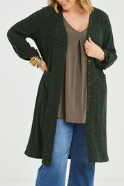 Model Jess wearing size 14 of the Into The Forest Cardi in colour Forest (Green), from the front, cropped image