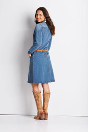 Model Clementine wearing size 8 of the Calamity Denim Dress in colour Denim (Blue), from the back