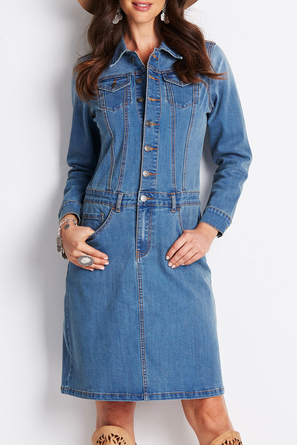 Model Clementine wearing size 8 of the Calamity Denim Dress in colour Denim (Blue), from the front, cropped image