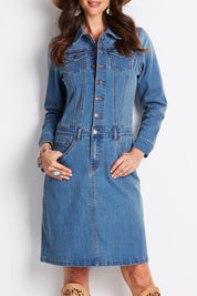 Model Clementine wearing size 8 of the Calamity Denim Dress in colour Denim (Blue), from the front, cropped image