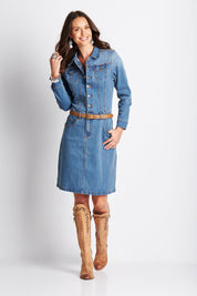 Model Clementine wearing size 8 of the Calamity Denim Dress in colour Denim (Blue), from the front, showing the whole outfit