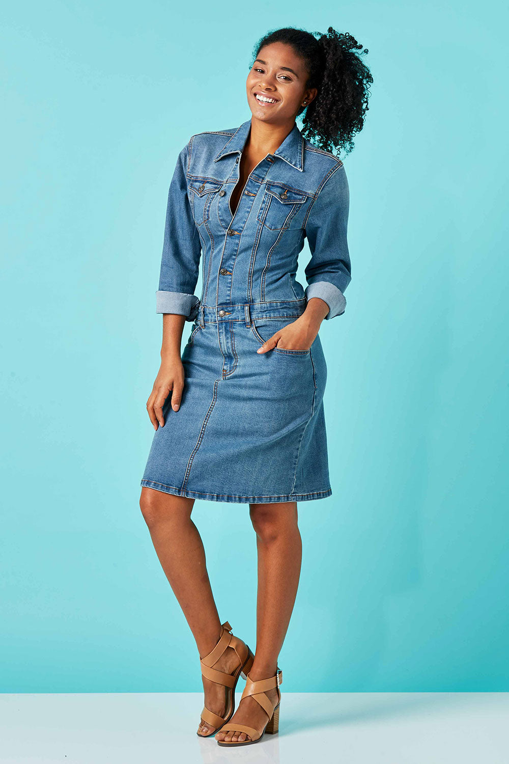 Model Grazi wearing size 10 of the Calamity Denim Dress in colour Denim (Blue), from the front, showing the whole outfit