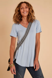 Model Emma wearing size 10 of the Softly Swinging Bamboo Tee in colour Chambray (Blue), from the front, cropped image