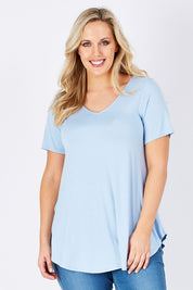 Model Jess wearing size 12 of the Softly Swinging Bamboo Tee in colour Chambray (Blue), from the front, cropped image