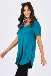 Model Georgia wearing size 10 of the Softly Swinging Bamboo Tee in colour Jewel (Green), from the front, cropped image