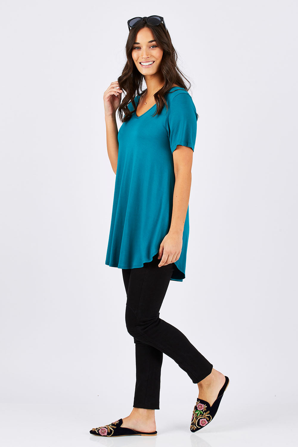 Model Georgia wearing size 10 of the Softly Swinging Bamboo Tee in colour Jewel (Green), from the front, showing the whole outfit