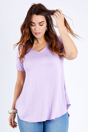 Model Laura wearing size 14 of the Softly Swinging Bamboo Tee in colour Lilac (Purple), from the front, cropped image