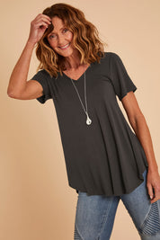 Model Emma wearing size 10 of the Softly Swinging Bamboo Tee in colour Storm (Grey), from the front, cropped image