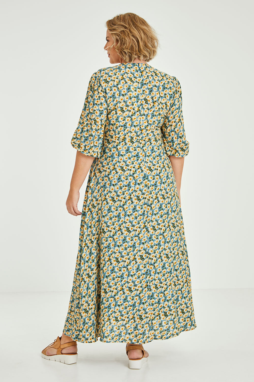 Model Fiona wearing size 16 of the Daisy Chain Swing Dress in colour Daisy (Blue), from the back