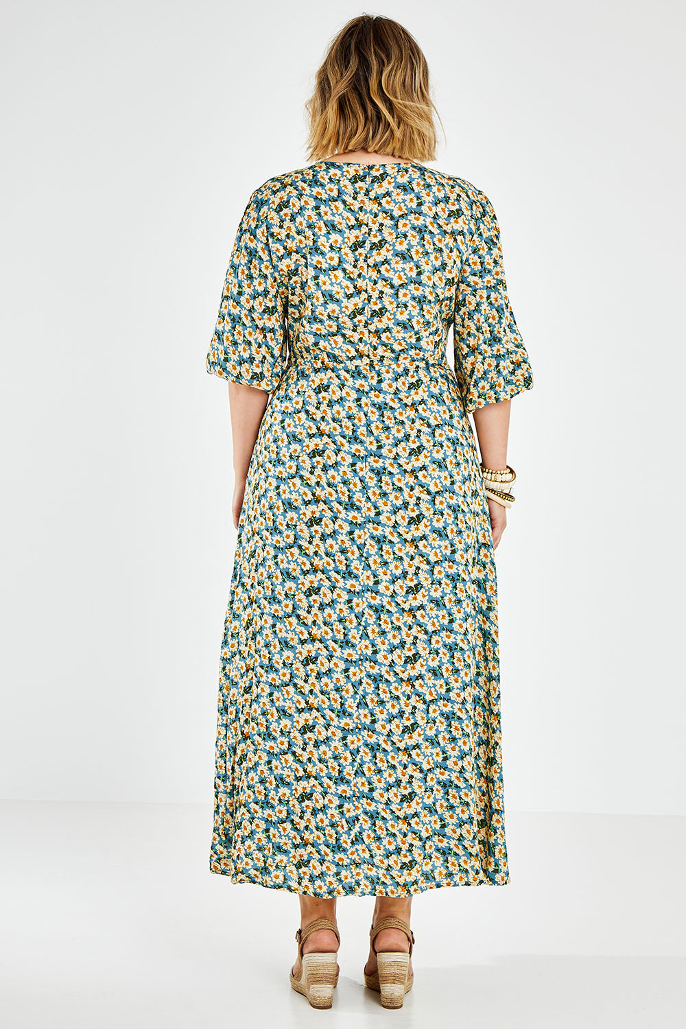 Model Jess wearing size 14 of the Daisy Chain Swing Dress in colour Daisy (Blue), from the back