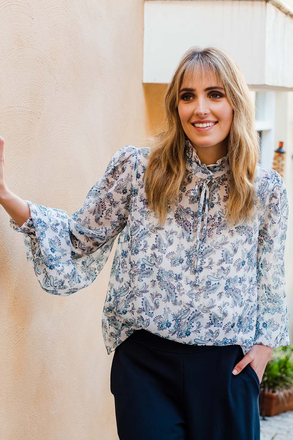 Model Tegan wearing size 10 of the Paisley Lady Blouse in colour Whtpaisley (White), from the front, showing the whole outfit