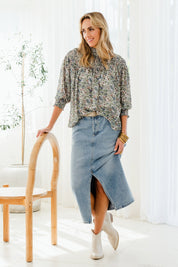 Model Tegan wearing size 10 of the Romance In The Air Blouse in colour Fleur (Green), from the front, showing the whole outfit