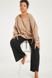 Model Noli wearing size 14 of the Good Times Gather Top in colour Latte, from the front, showing the whole outfit