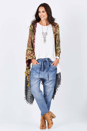 Model Clementine wearing size 10 of the With My Tribe Pants in colour Denim (Blue), from the front, showing the whole outfit