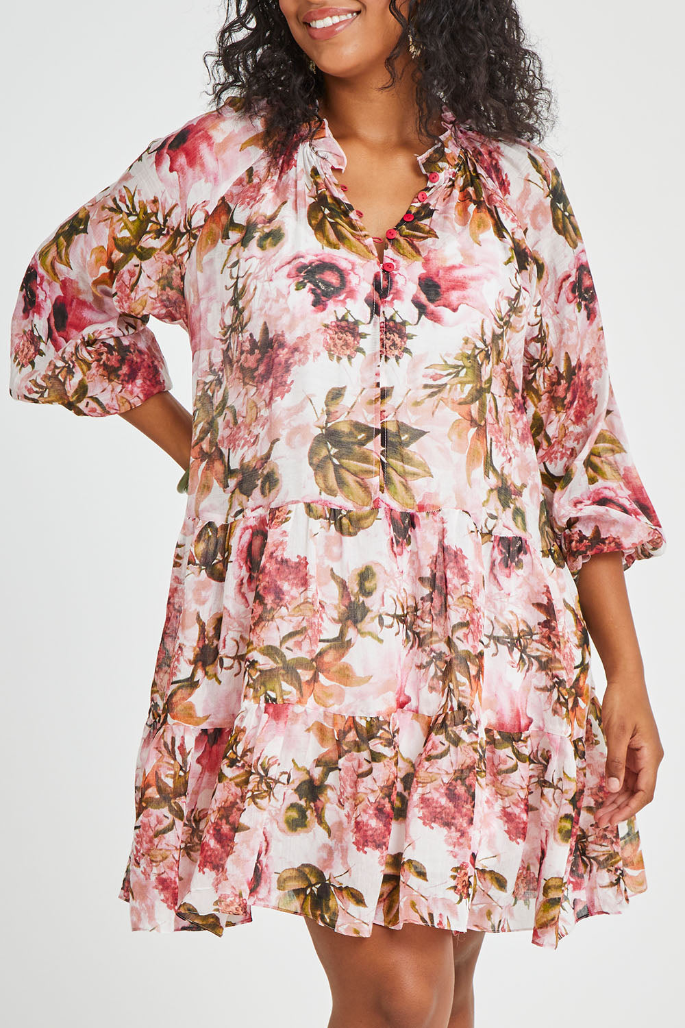 Model Noli wearing size 14 of the Down The Garden Path Dress in colour Fleur (Pink), from the front, cropped image
