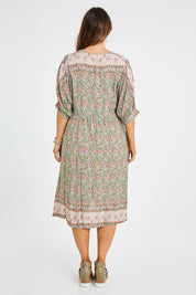 Model Laura wearing size 14 of the Sunshine And Flowers Smock Dress in colour Sagefleur (Green), from the back